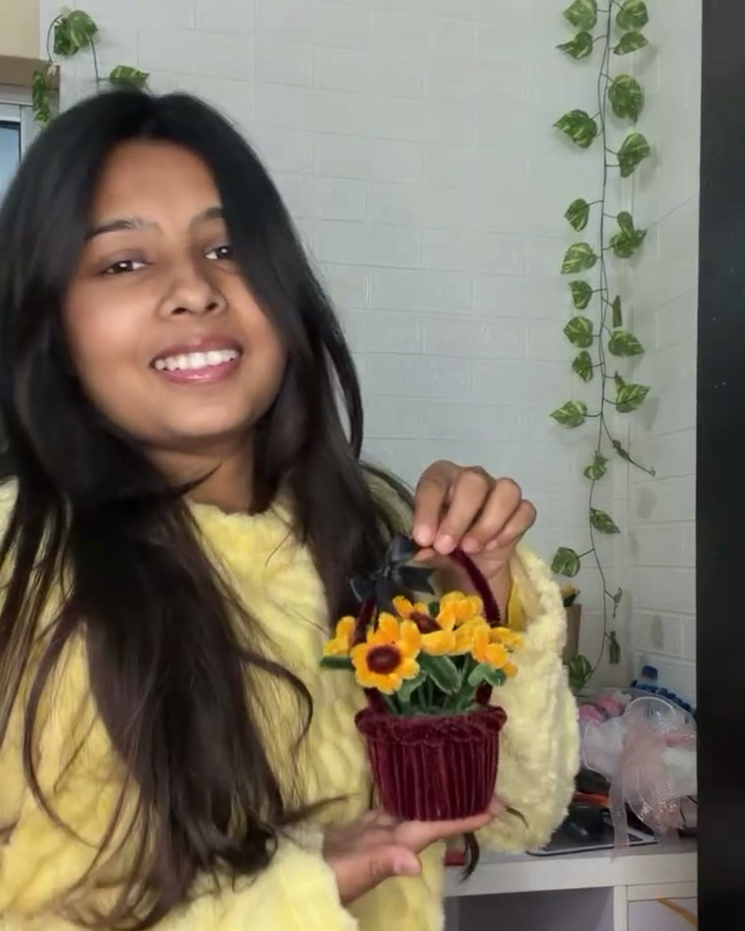 Taniya, the maker behind Hollydaff, holding a sunflower basket